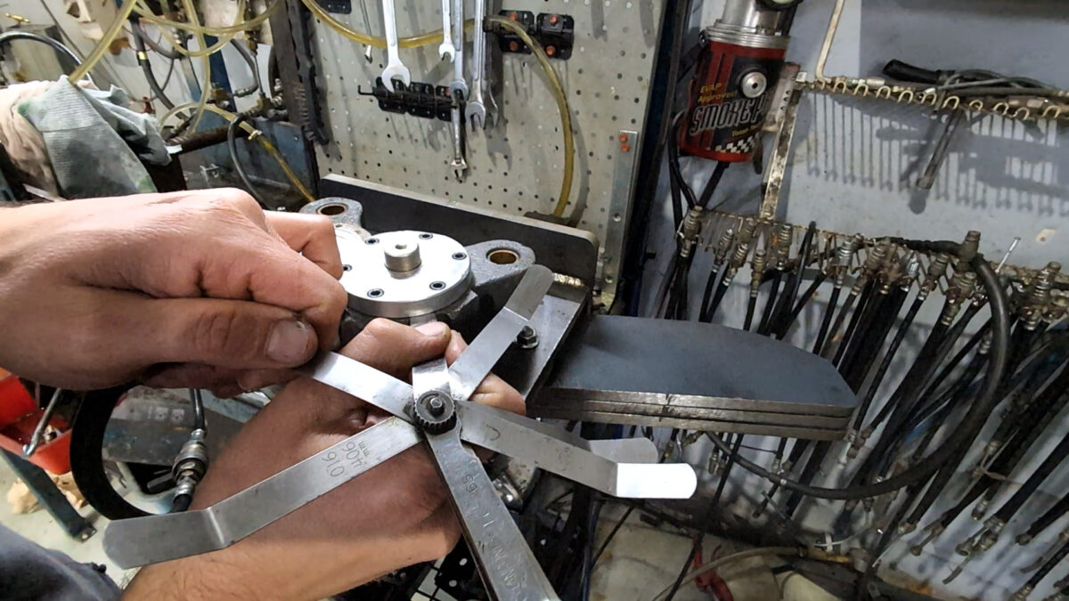 Photo of a feeler gauge, testing the piston bores trueness.