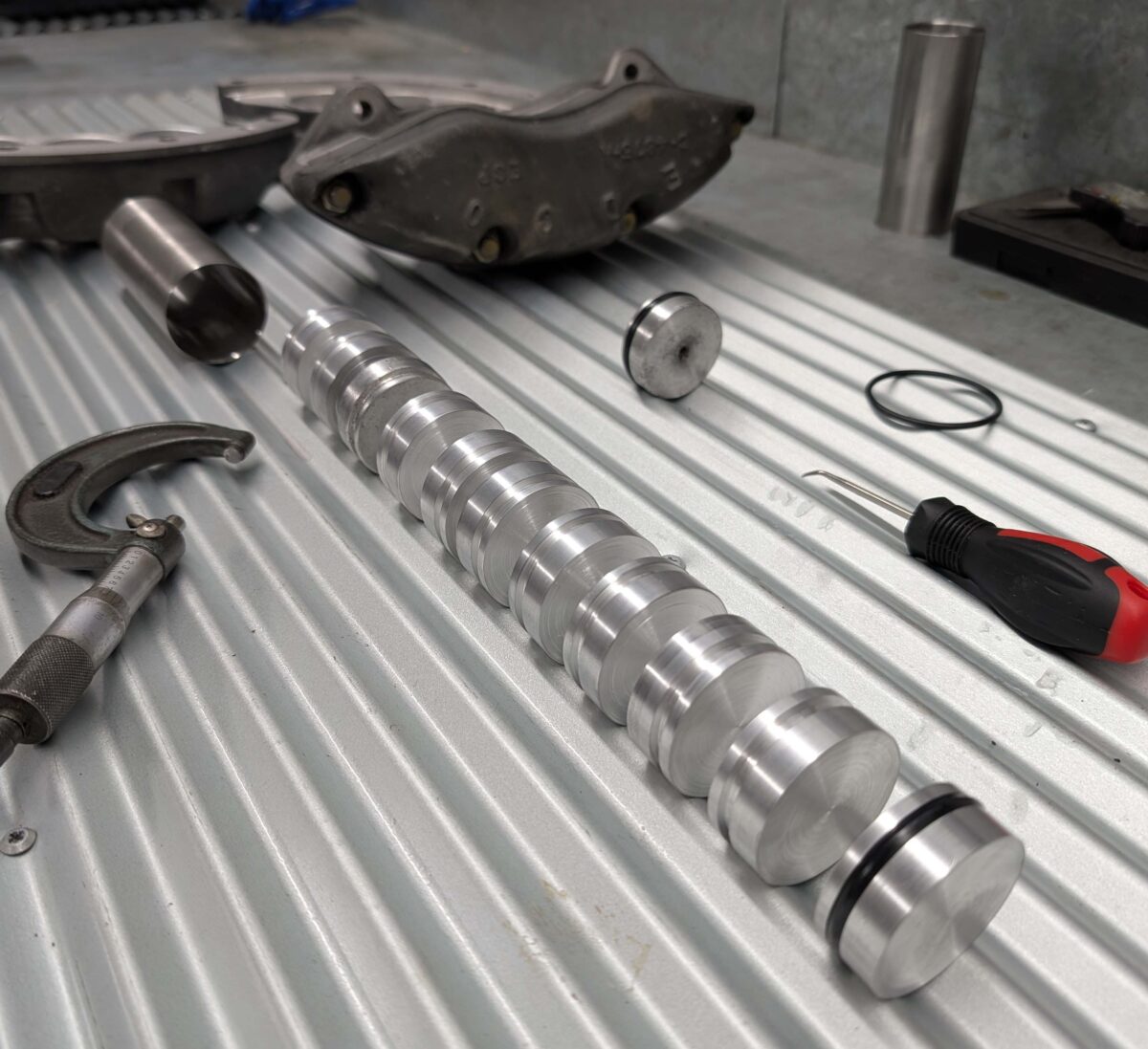 Photo of new pistons on bench
